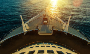 Cruise Ship Ocean Crossing:ship,vessel,cruise ship,cruise,boat,ocean,transportation,vacation,ocean liner,nautical,marine,marina,water,sea,deck,holiday,vacation,getaway,adventure,fun,transport,voyage,sail,tour,tourist,horizontal,front,sun,sunset,waves,wave